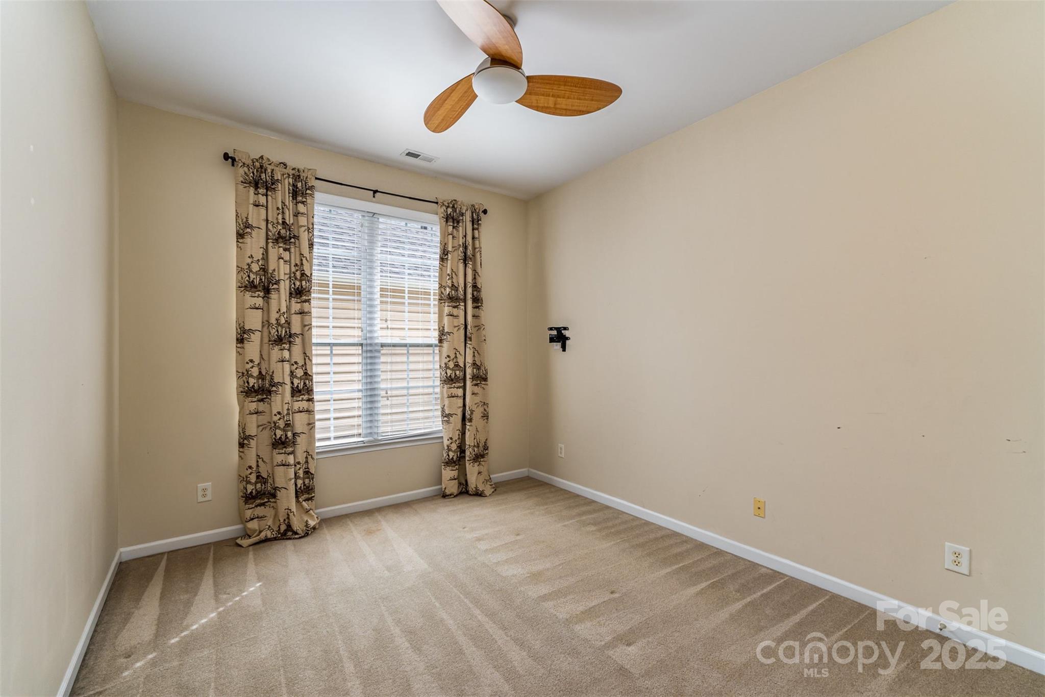 418 Garnet Court Fort Mill, SC 29708 - Photo 19 of 29 an empty room with windows and chandelier fan