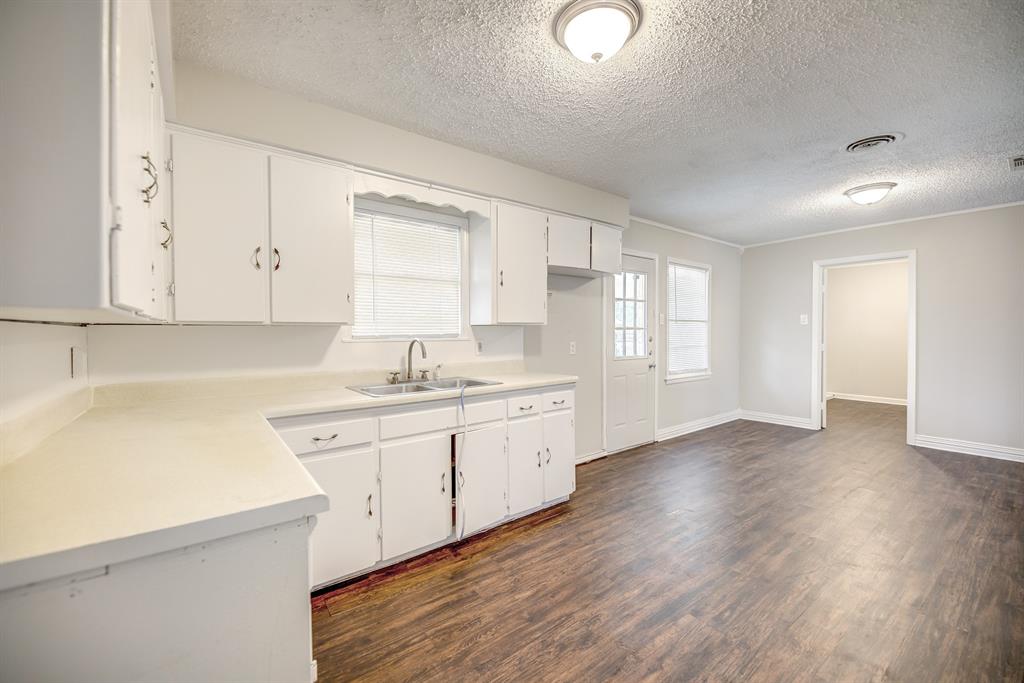 3635 Rogene Street North Richland Hills, TX 76180 - Photo 11 of 25 a kitchen with sink cabinets and wooden floor