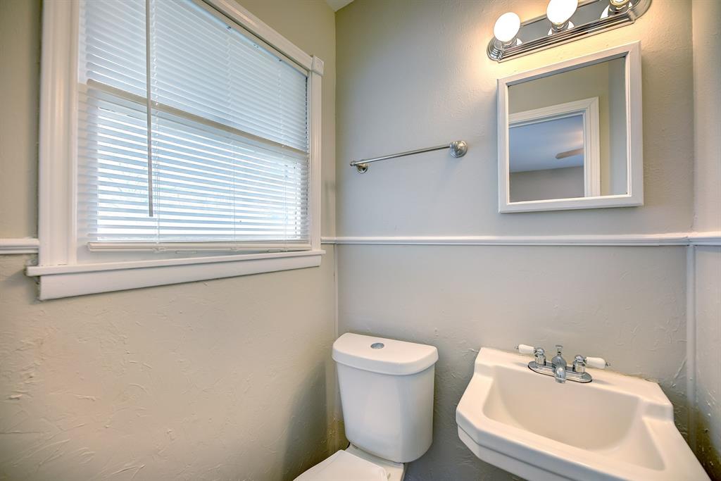 3635 Rogene Street North Richland Hills, TX 76180 - Photo 22 of 25 a bathroom with a toilet sink and mirror