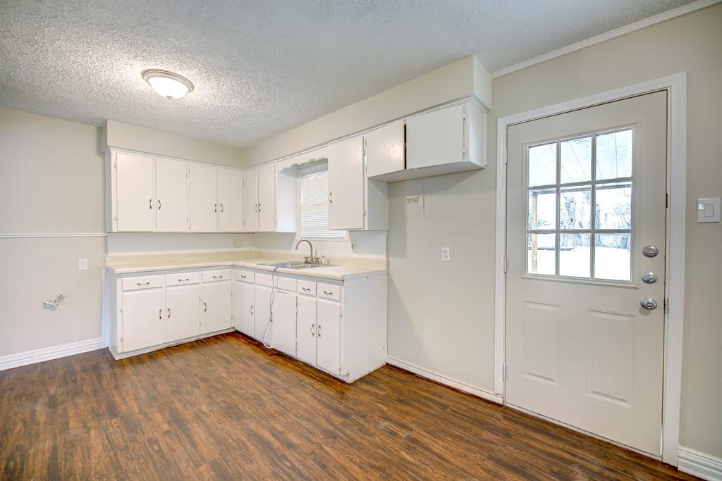 3635 Rogene Street North Richland Hills, TX 76180 - Photo 9 of 25 a kitchen with wooden floors and white appliances