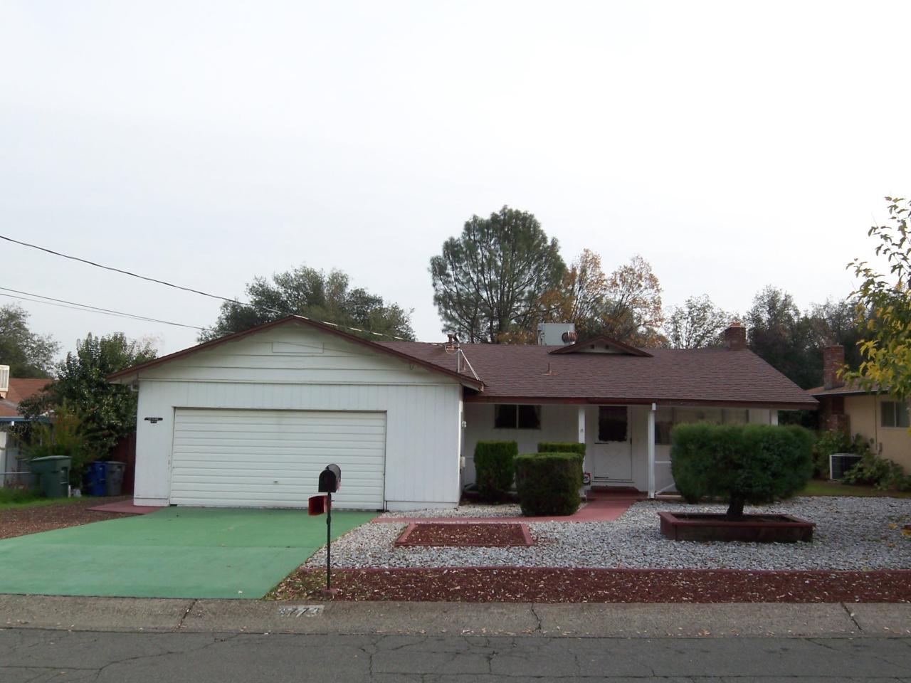 3773 Alma Avenue Redding, CA 96002 - Photo 1 of 12 a front view of a house with garden