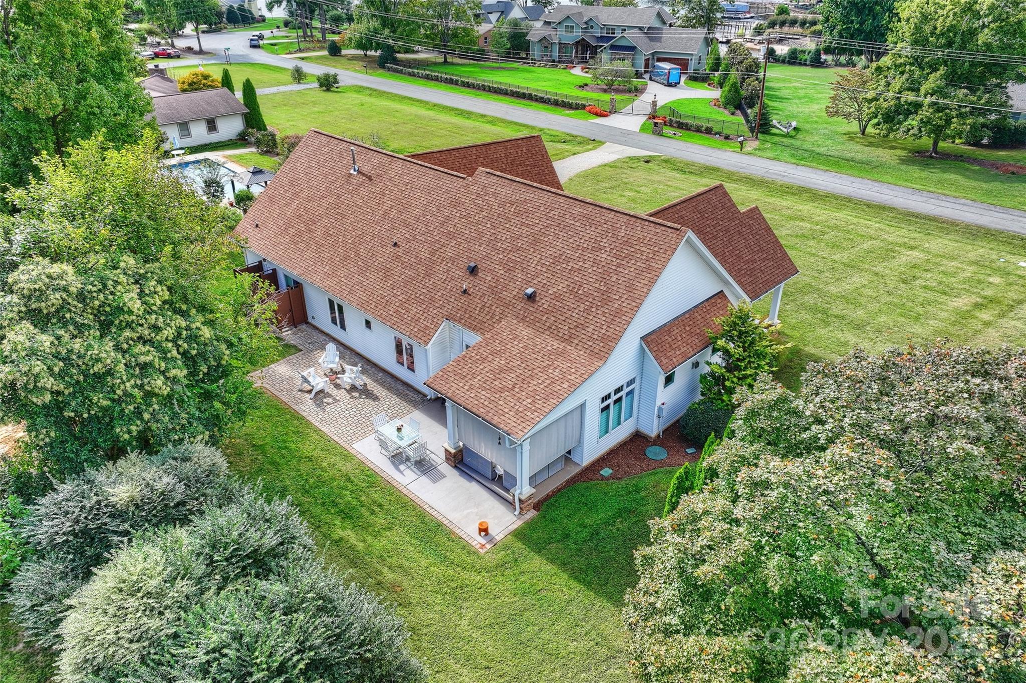an aerial view of a house with a garden and swimming pool