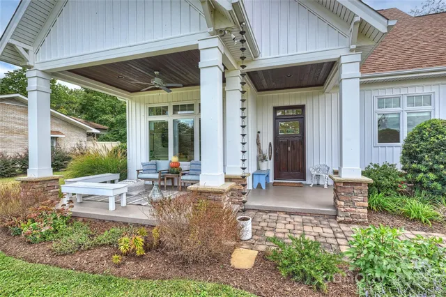 a view of a house with backyard sitting area and garden