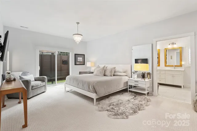 a spacious bedroom with a bed couch and a dresser