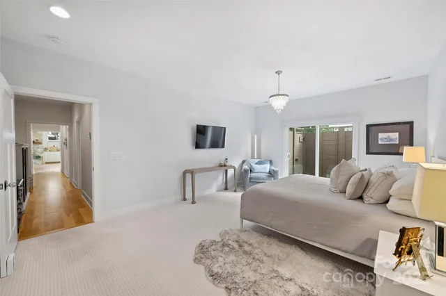 a bedroom with a large bed and a couch