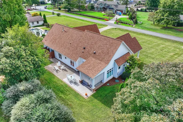 an aerial view of a house with a garden and swimming pool