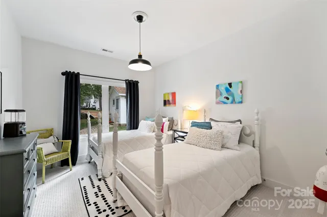 a bedroom with furniture and a chandelier