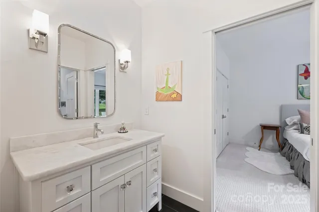 a bathroom with a sink a toilet and mirror