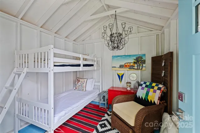 a bedroom with furniture and a book shelf