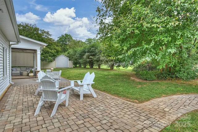 a view of a chairs and table in backyard of the house