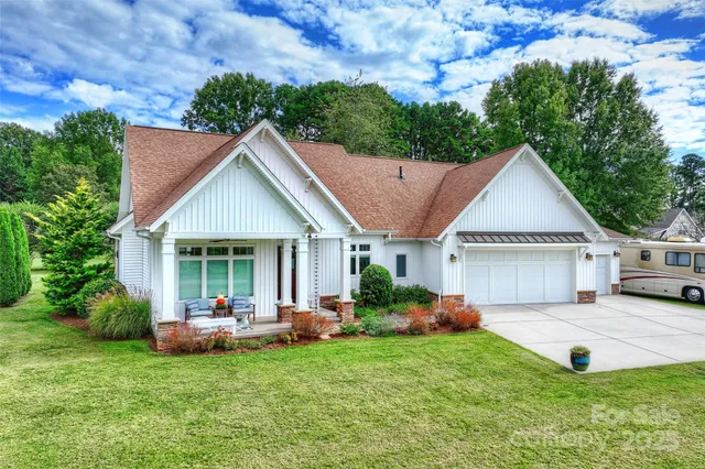 a front view of house with yard and outdoor seating