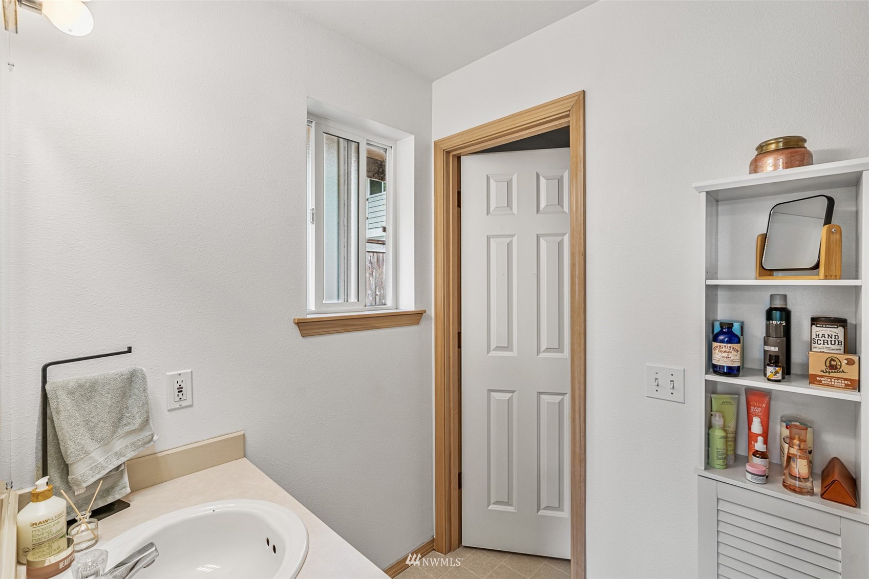 19329 Winesap Road Bothell, WA 98012 - Photo 18 of 32 a bathroom with a toilet sink vanity and mirror