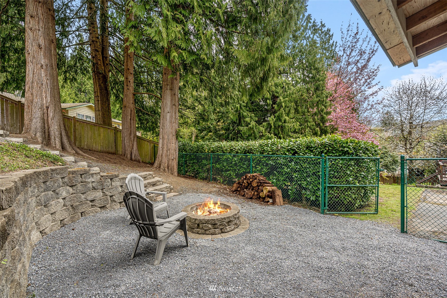 19329 Winesap Road Bothell, WA 98012 - Photo 27 of 32 a view of a backyard with table and chairs potted plants and large tree