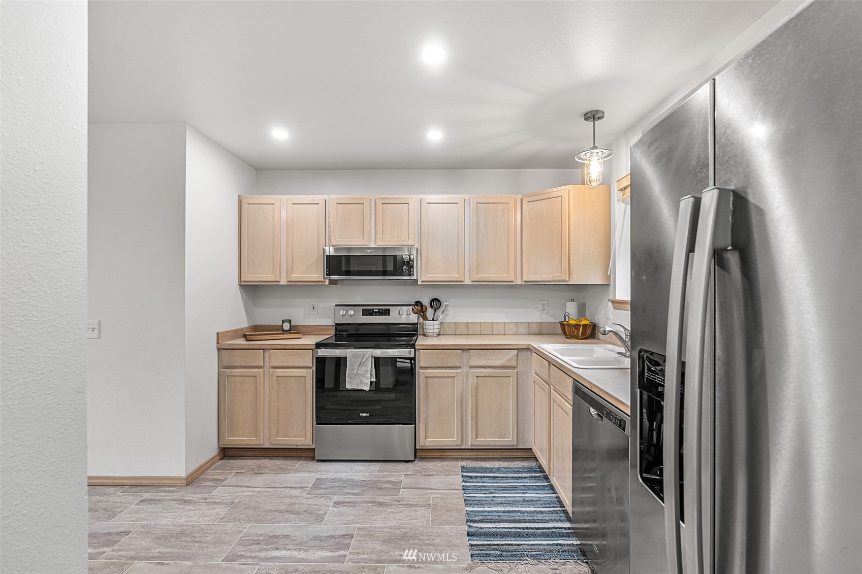 19329 Winesap Road Bothell, WA 98012 - Photo 7 of 32 a kitchen with stainless steel appliances cabinets a sink and a stove