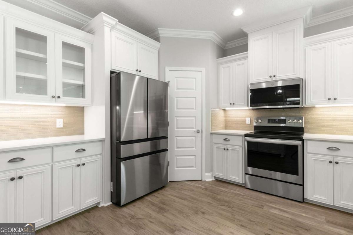 107 Amanda Trace Kingsland, GA 31548 - Photo 12 of 94 a kitchen with stainless steel appliances a refrigerator stove and microwave