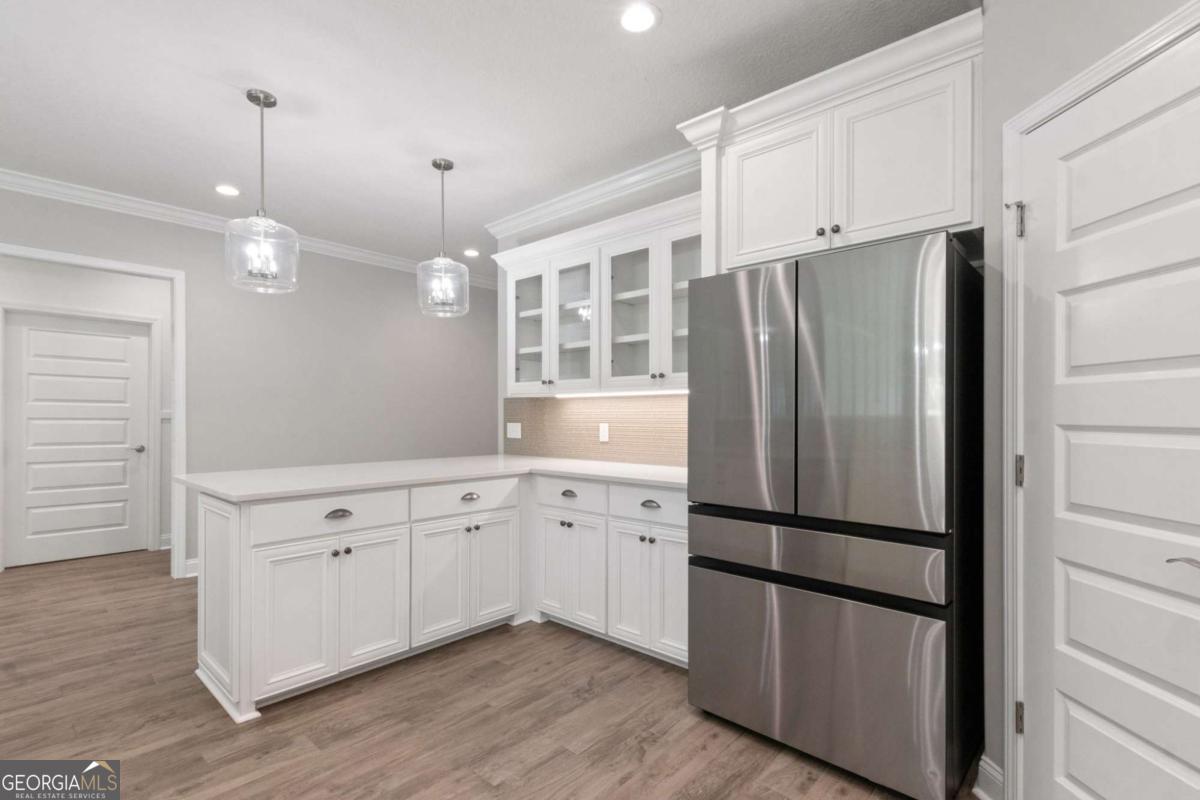 107 Amanda Trace Kingsland, GA 31548 - Photo 14 of 94 a kitchen with stainless steel appliances granite countertop a refrigerator a sink and a stove with wooden floor