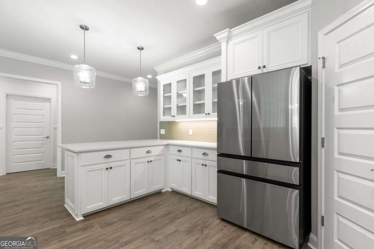 107 Amanda Trace Kingsland, GA 31548 - Photo 15 of 94 a kitchen with stainless steel appliances granite countertop a refrigerator a sink and white cabinets