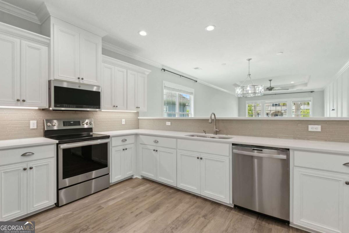 107 Amanda Trace Kingsland, GA 31548 - Photo 17 of 94 a kitchen with sink a microwave and cabinets