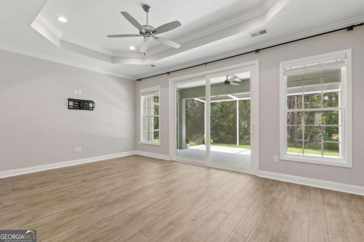 107 Amanda Trace Kingsland, GA 31548 - Photo 20 of 94 a view of an empty room with a window and wooden floor