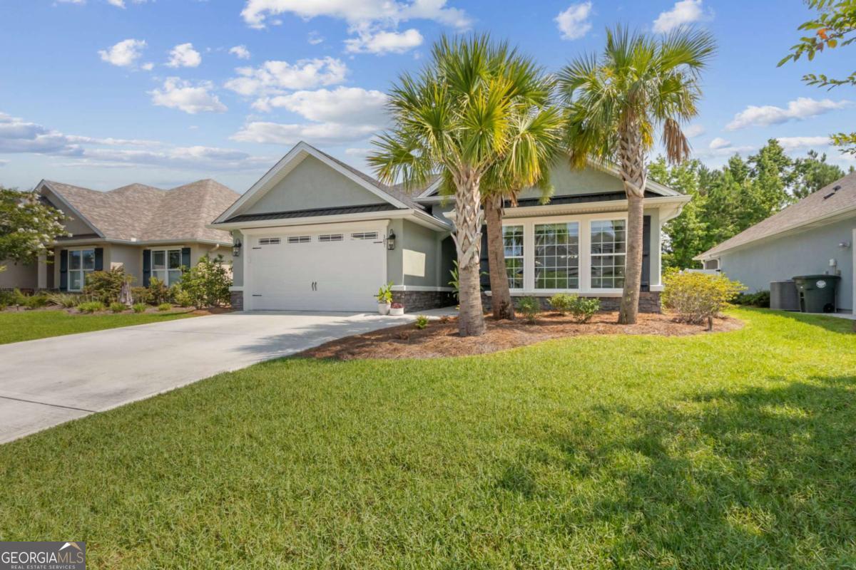 107 Amanda Trace Kingsland, GA 31548 - Photo 2 of 94 a view of a house with a yard and potted plants
