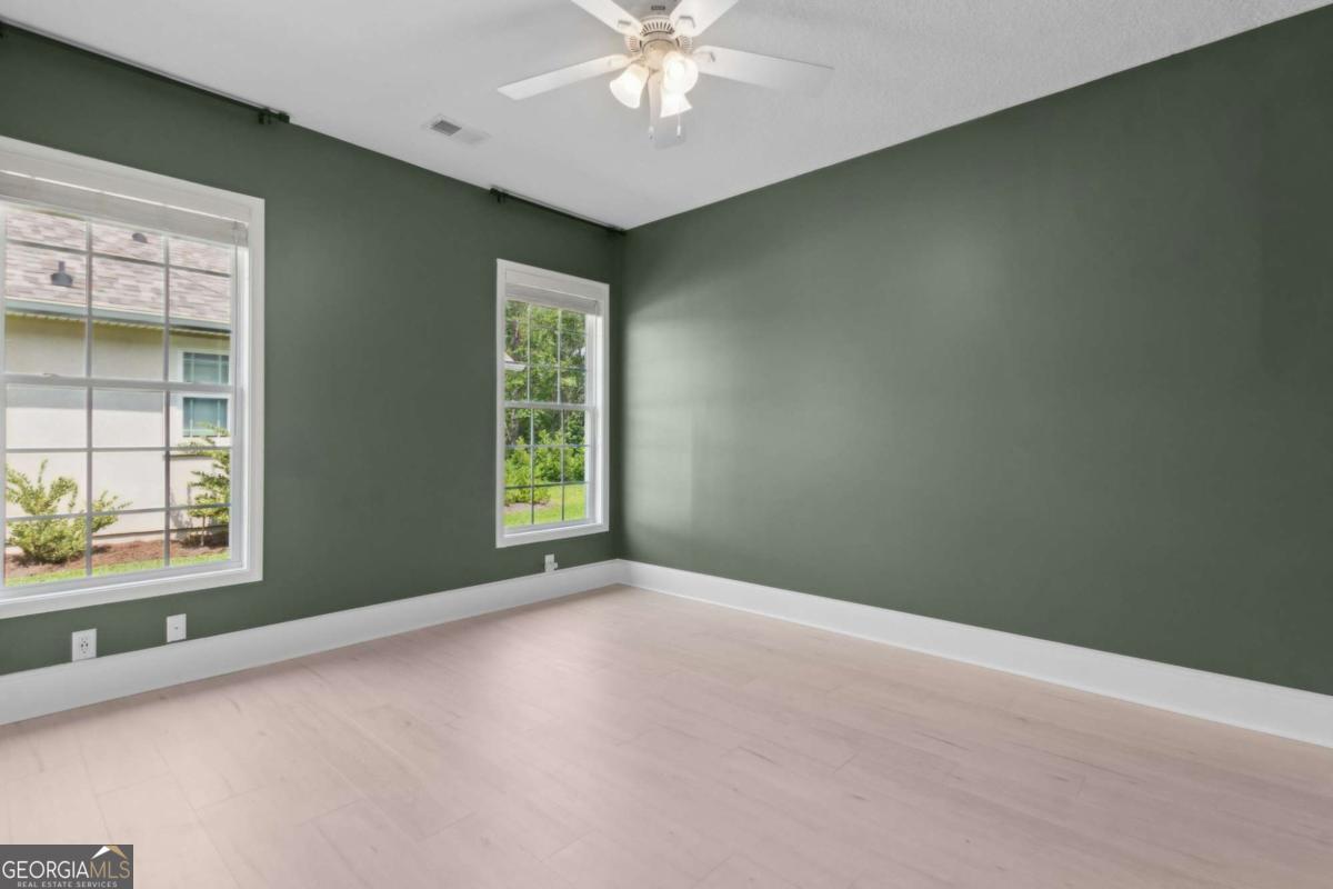107 Amanda Trace Kingsland, GA 31548 - Photo 32 of 94 an empty room with a window and a ceiling fan