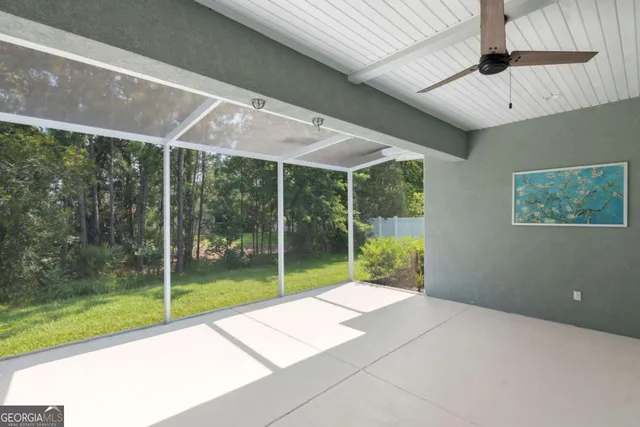 a view of a big yard with a house in the background