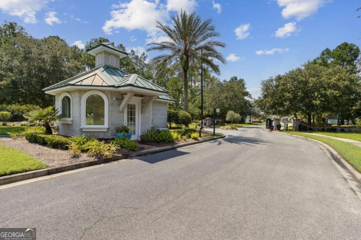 107 Amanda Trace Kingsland, GA 31548 - Photo 74 of 94 a front view of a house with a garden and a yard
