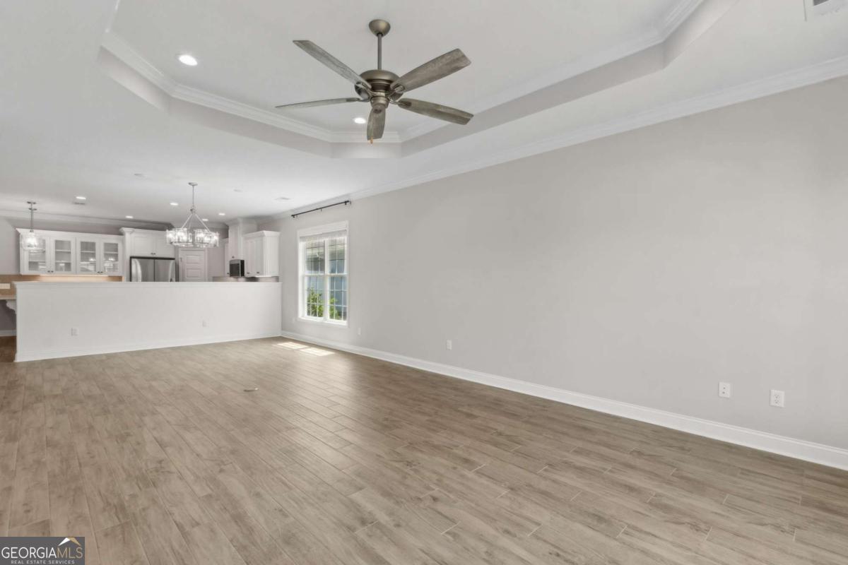 107 Amanda Trace Kingsland, GA 31548 - Photo 8 of 94 an empty room with wooden floor and windows