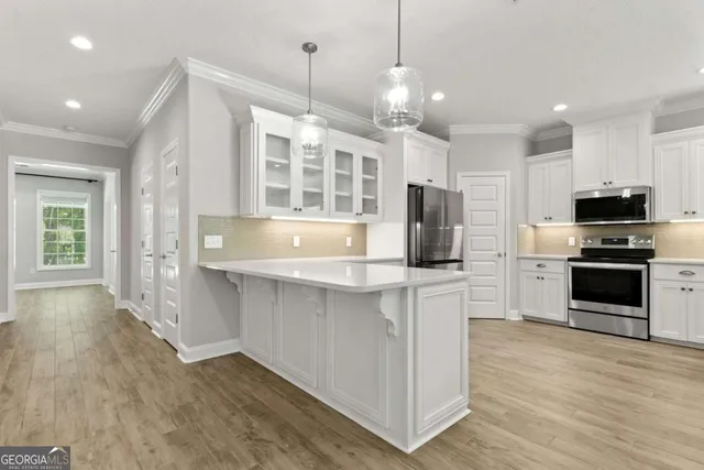 a kitchen with stainless steel appliances a refrigerator stove and microwave