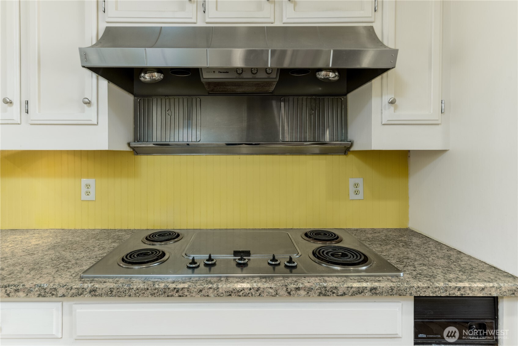 103 Turnagain Place Sequim, WA 98382 - Photo 12 of 40 a kitchen with a sink stove and cabinets
