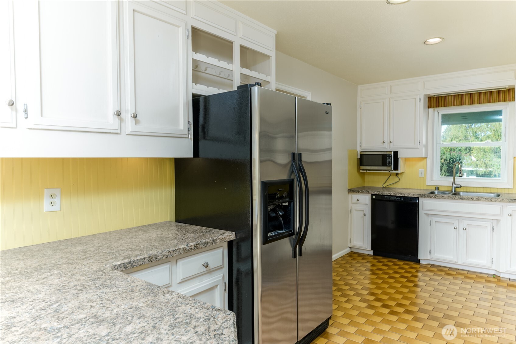 103 Turnagain Place Sequim, WA 98382 - Photo 15 of 40 a kitchen with a refrigerator sink and stove
