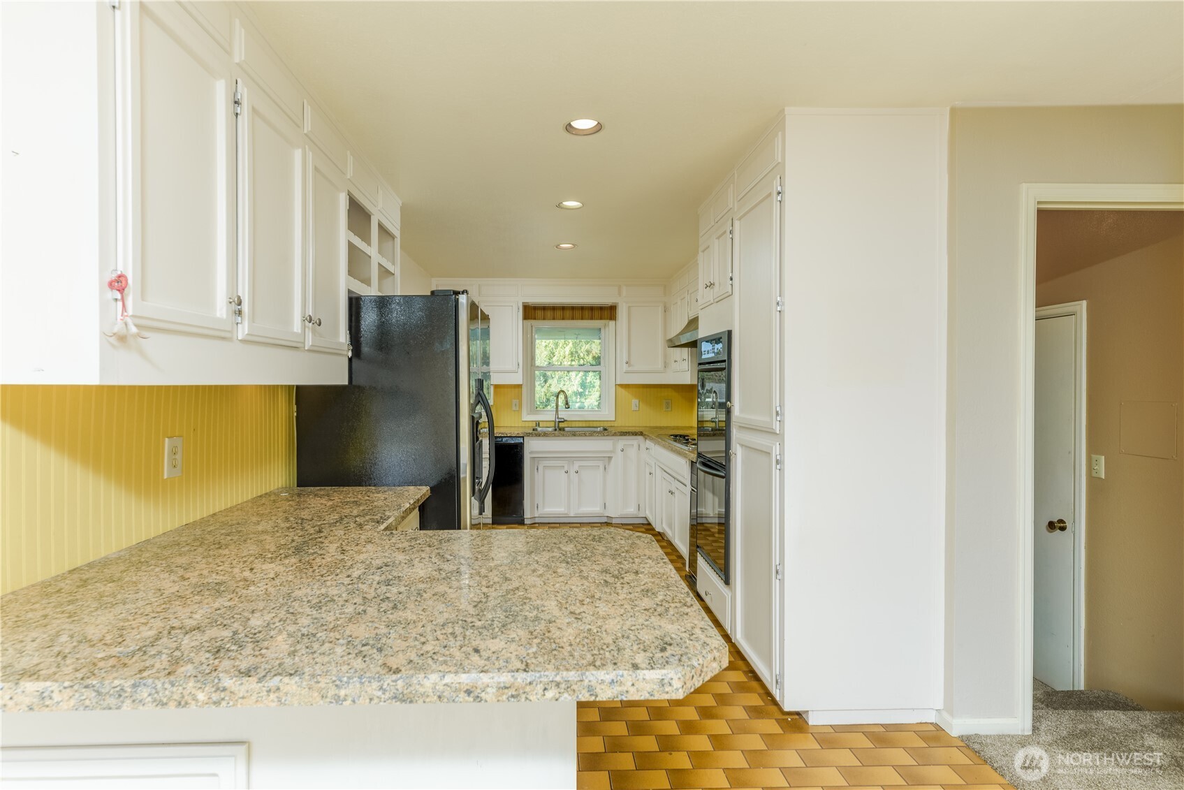 103 Turnagain Place Sequim, WA 98382 - Photo 16 of 40 a kitchen with refrigerator and window