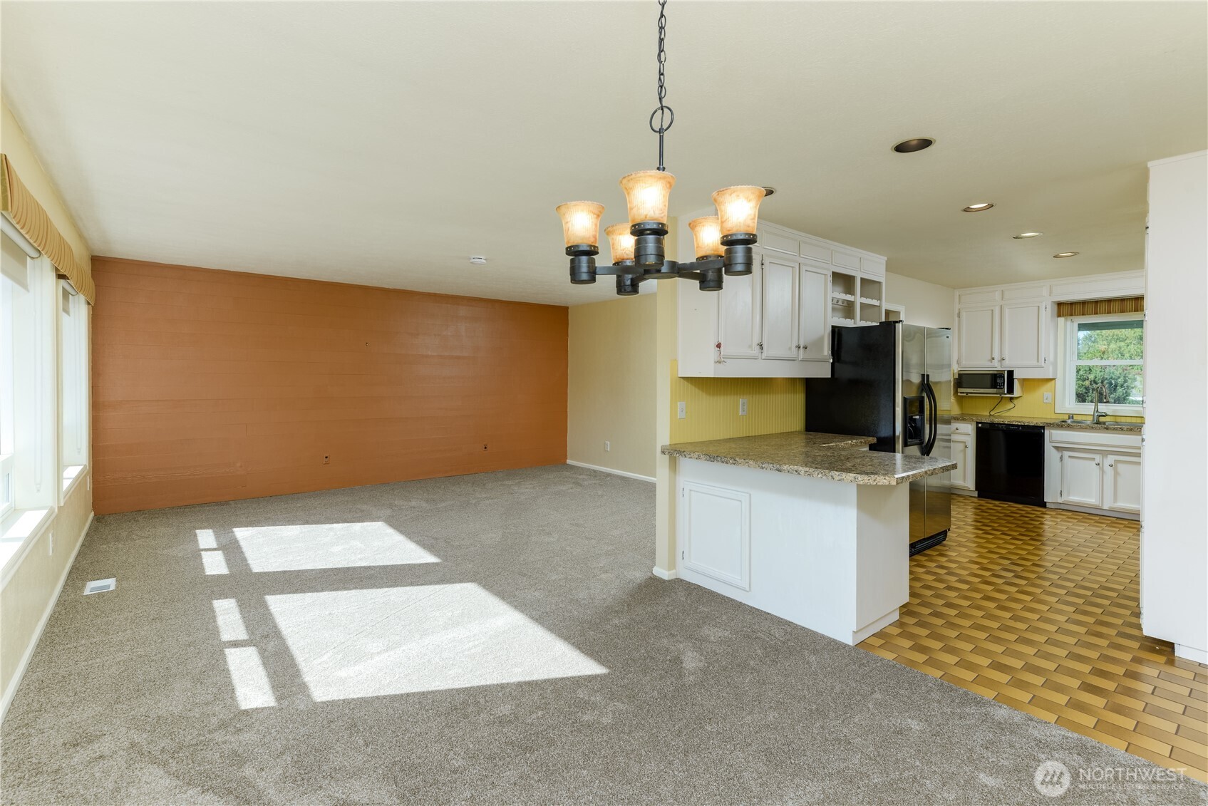 103 Turnagain Place Sequim, WA 98382 - Photo 17 of 40 a view of a kitchen with a sink and dishwasher a refrigerator with wooden floor