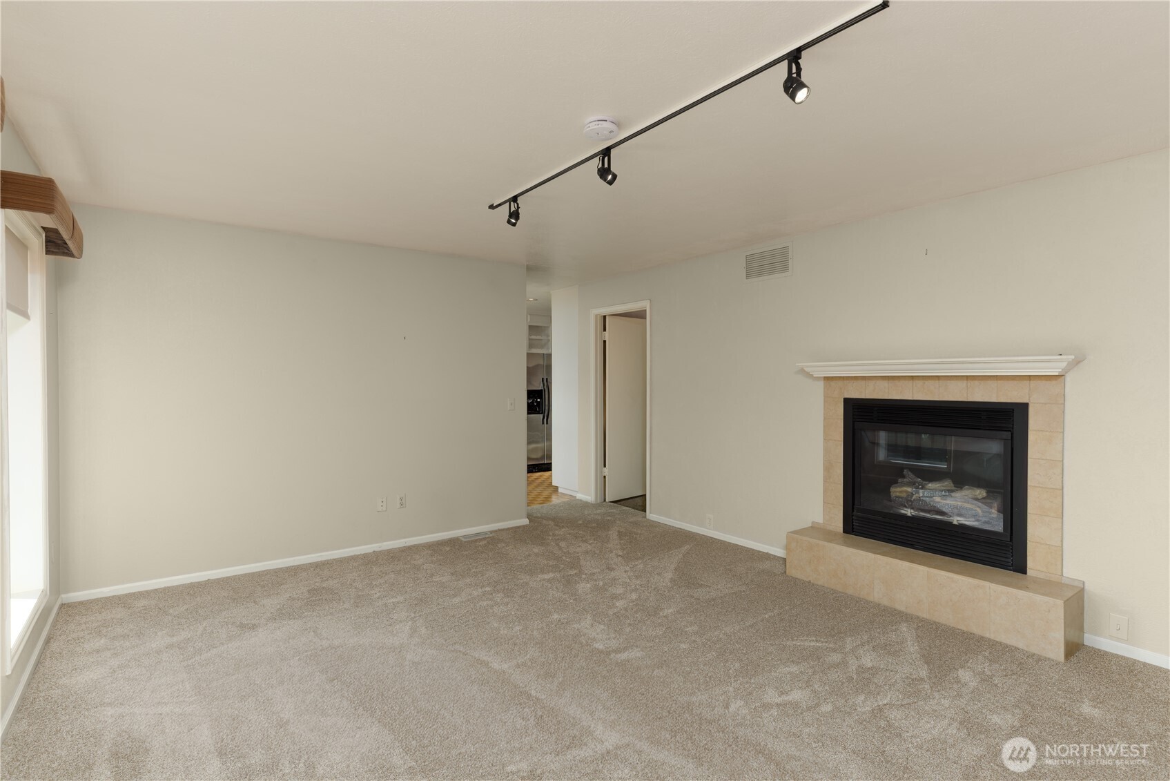 103 Turnagain Place Sequim, WA 98382 - Photo 20 of 40 a view of an empty room with a fireplace