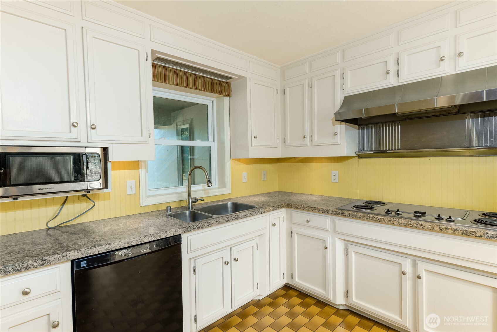 103 Turnagain Place Sequim, WA 98382 - Photo 10 of 40 a kitchen with granite countertop stainless steel appliances a stove sink and microwave