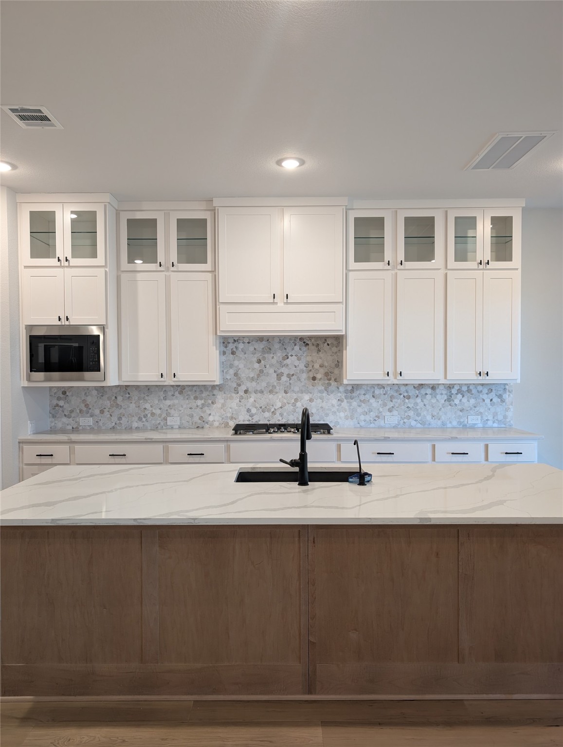 a kitchen with granite countertop a sink and cabinets