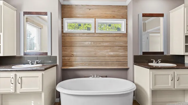 a bathroom with a sink a toilet and a window