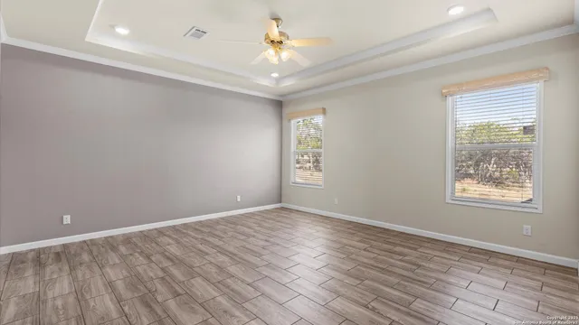 wooden floor in an empty room with a window