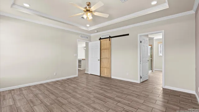 an empty room with wooden floor and door