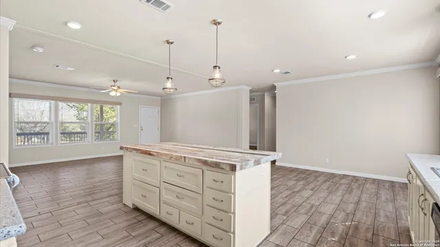 a open kitchen with stainless steel appliances granite countertop a sink a stove and a wooden floors