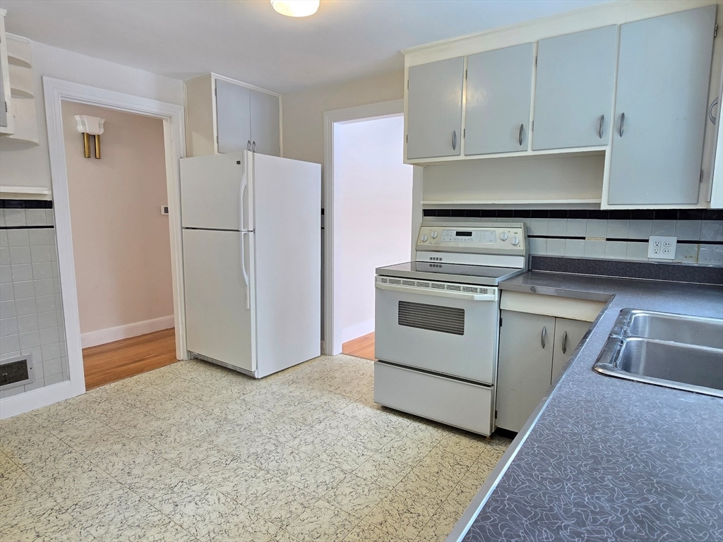 37 Riverview Drive Ashland, MA 01721 - Photo 16 of 30 a kitchen with a stove and a refrigerator