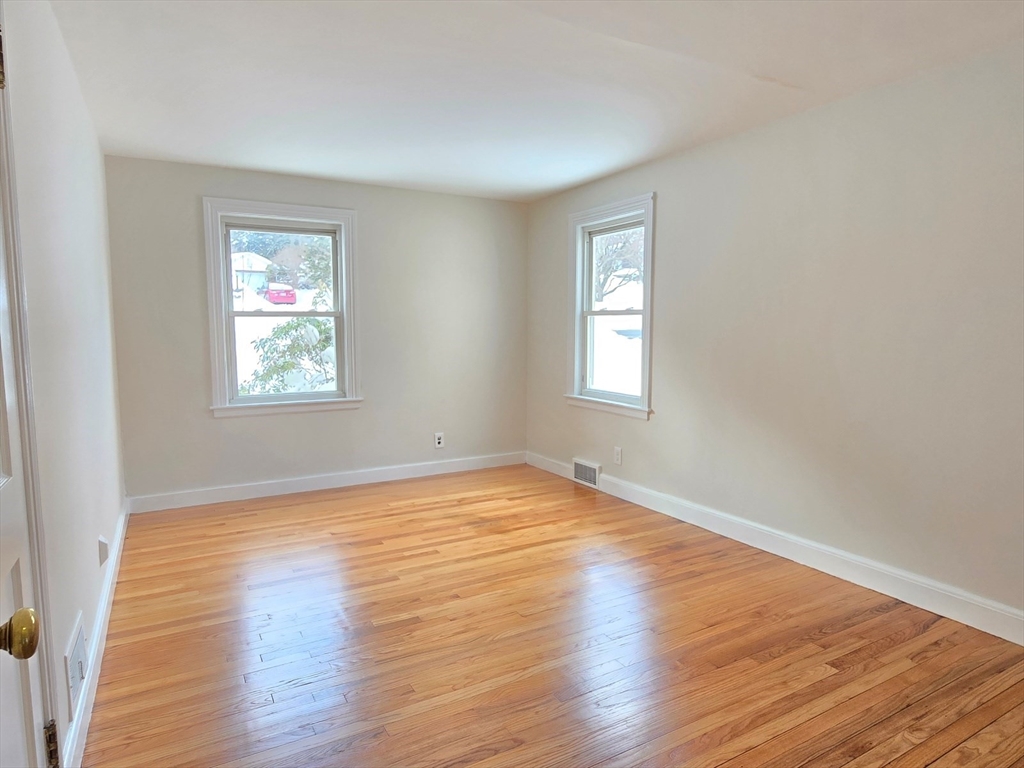 37 Riverview Drive Ashland, MA 01721 - Photo 19 of 30 a view of an empty room with wooden floor and a window