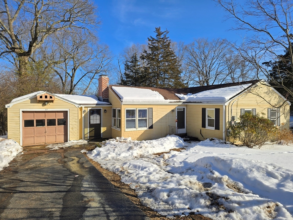 37 Riverview Drive Ashland, MA 01721 - Photo 2 of 30 a front view of a house with a yard covered in snow