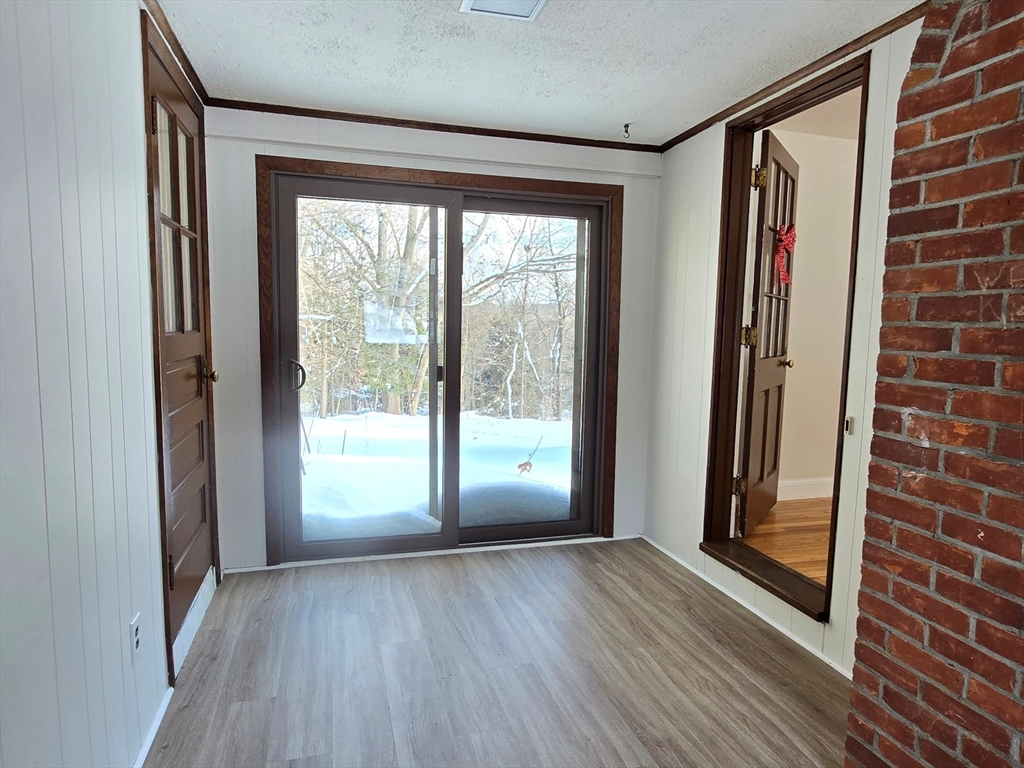 37 Riverview Drive Ashland, MA 01721 - Photo 3 of 30 a view of an empty room with wooden floor and a window