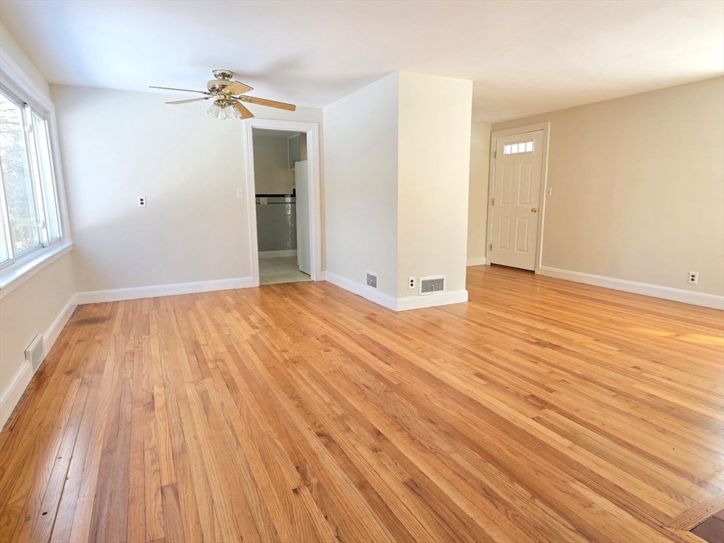 37 Riverview Drive Ashland, MA 01721 - Photo 5 of 30 a view of an empty room with wooden floor and a window