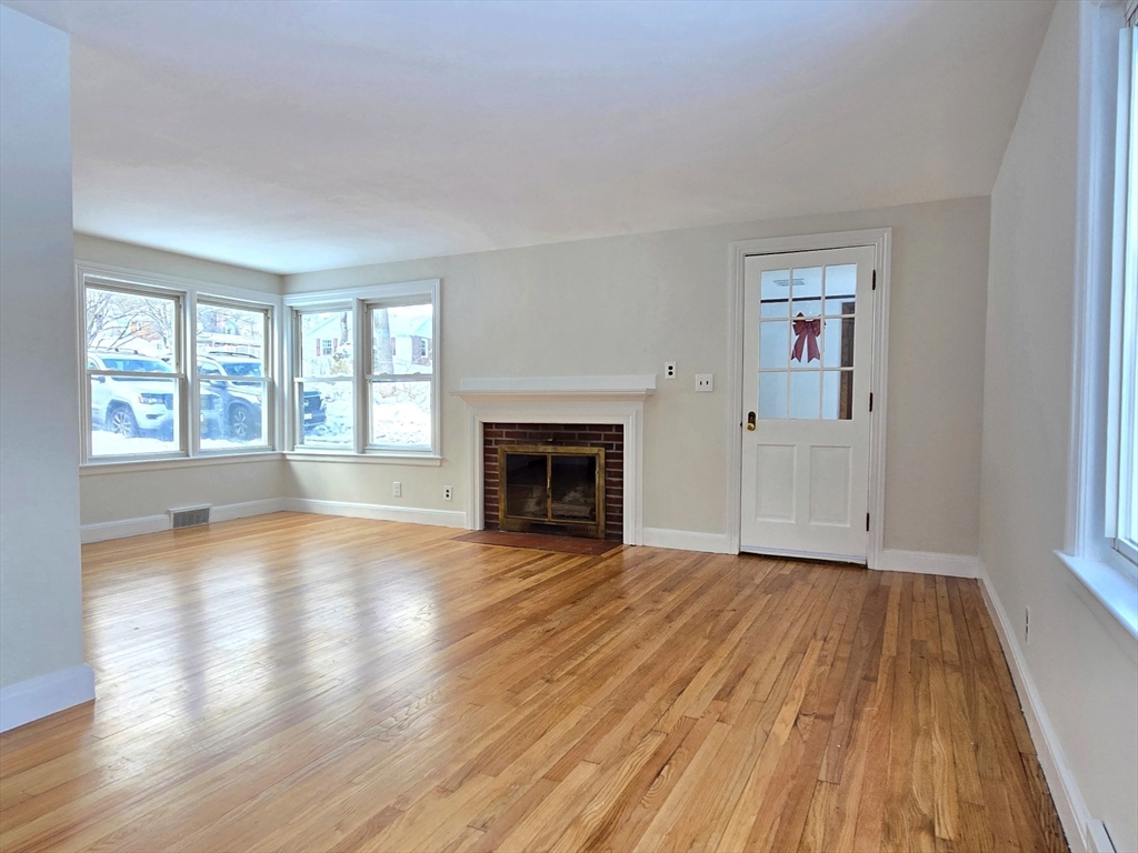 37 Riverview Drive Ashland, MA 01721 - Photo 6 of 30 wooden floor fireplace and windows in an empty room