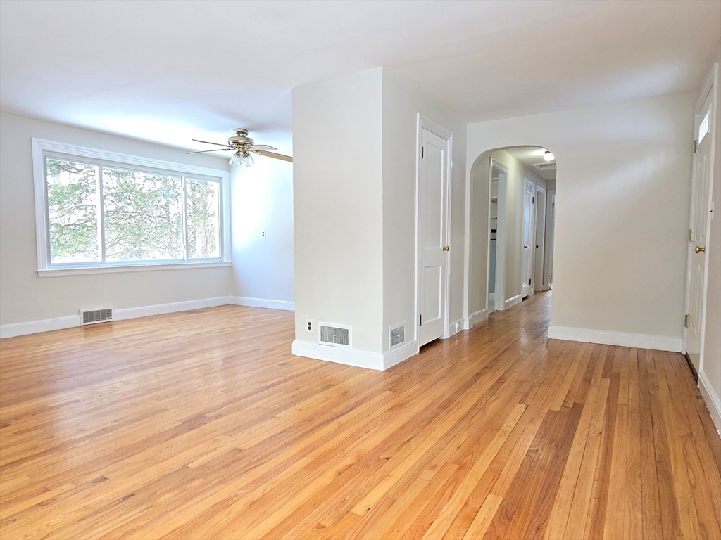 37 Riverview Drive Ashland, MA 01721 - Photo 9 of 30 an empty room with wooden floor and windows