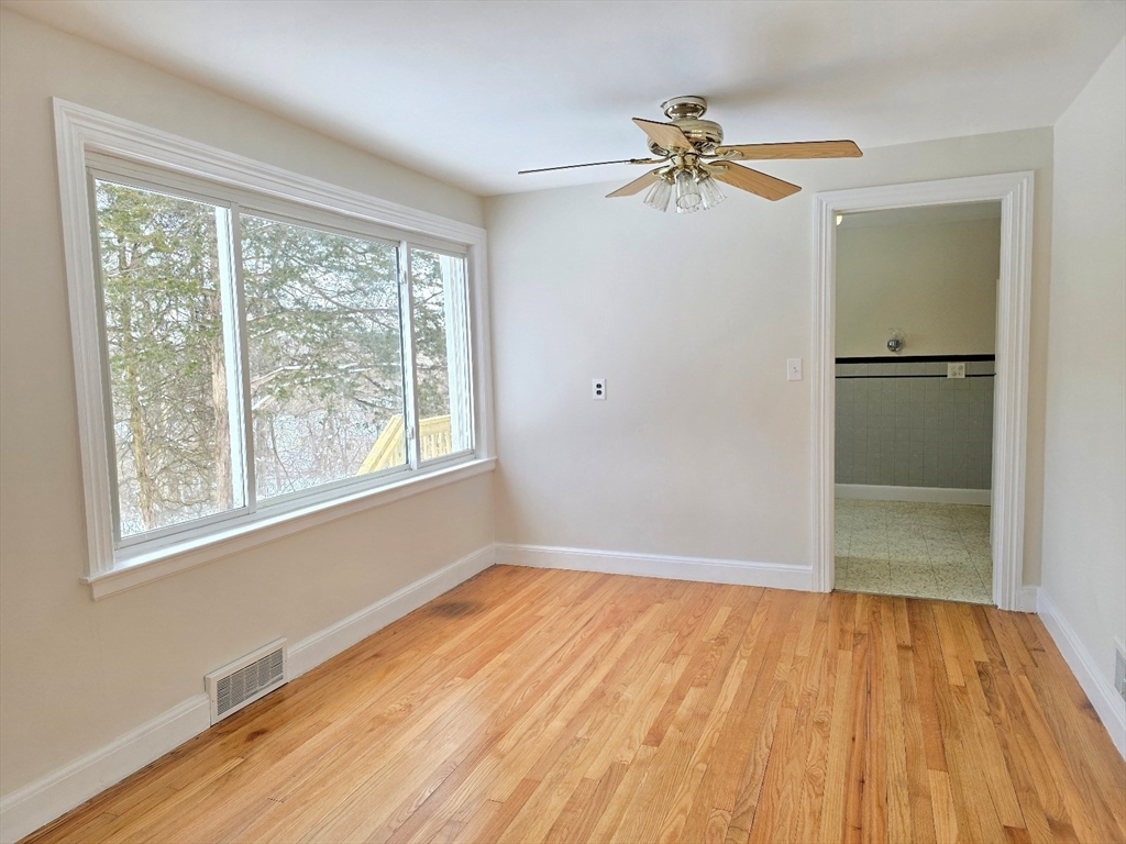 37 Riverview Drive Ashland, MA 01721 - Photo 10 of 30 a view of a room with wooden floor a ceiling fan and windows