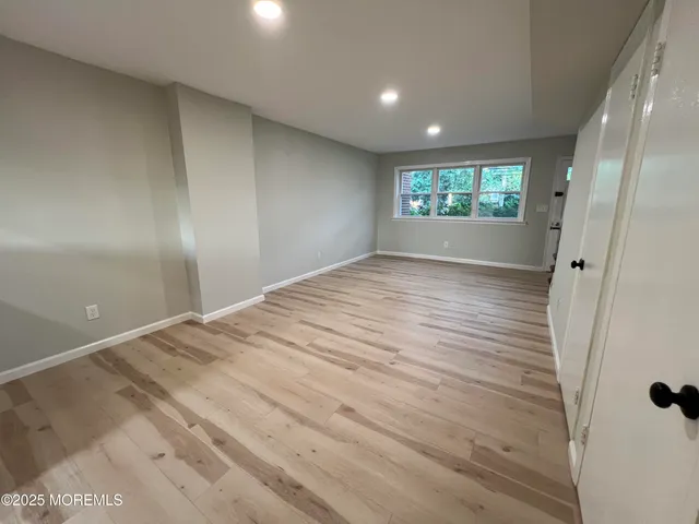 a view of an empty room and a window