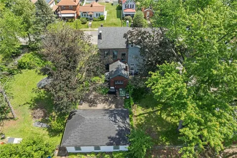 an aerial view of a house with a yard basket ball court and outdoor seating